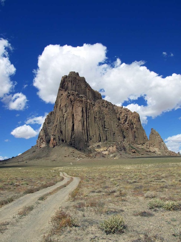 Photo of road leading up to Shiprock and Shiprock. Vertical.